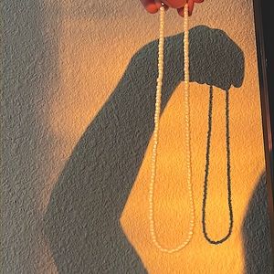 White pearl necklace with a gold clasp.